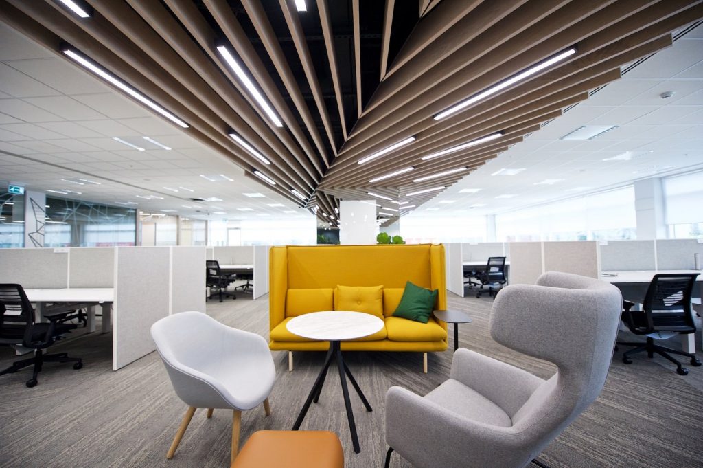 Open-plan floor with timber baffle ceiling & soft seating — commercial interior design by Ab & Zen Interior