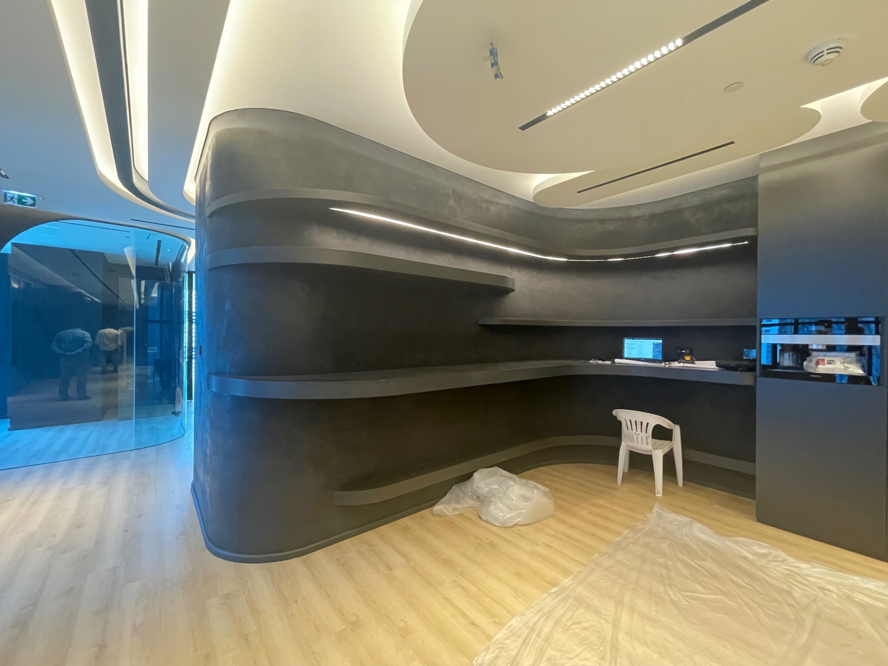 Curved micro-cement pantry with floating shelves — complete fit-out execution and handover by Ab & Zen Interior