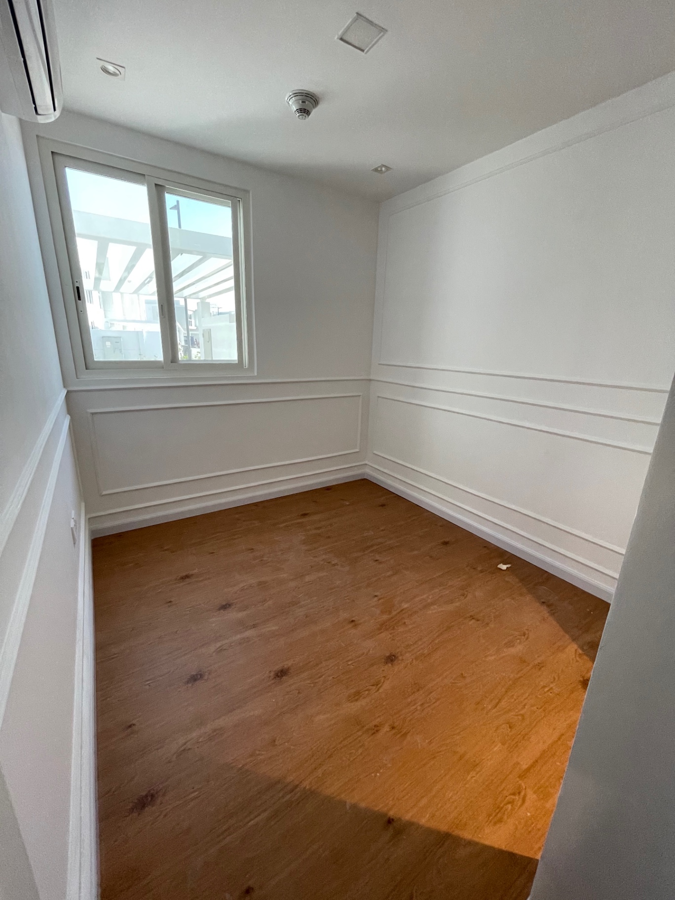 Compact bedroom with wainscoting & oak flooring — residential renovation in the Netherlands by Ab & Zen Interior