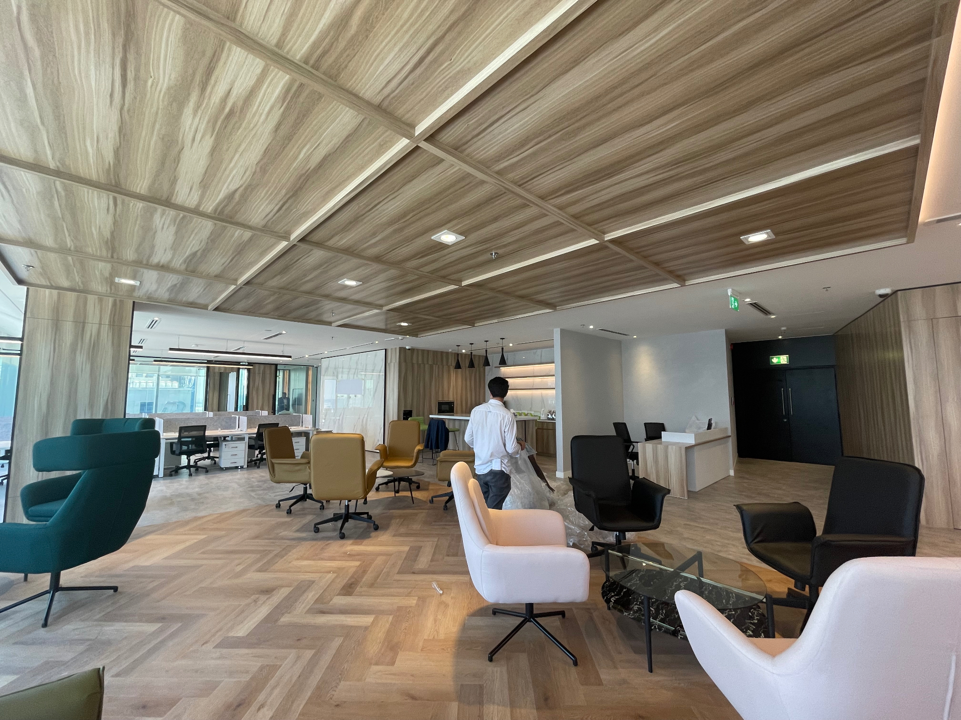 Timber coffered ceiling & herringbone lounge — corporate office delivered from design to execution by Ab & Zen Interior