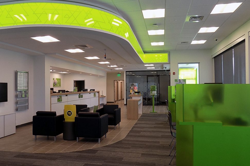 Retail-style branch interior with illuminated bulkhead — commercial interior design by Ab & Zen Interior