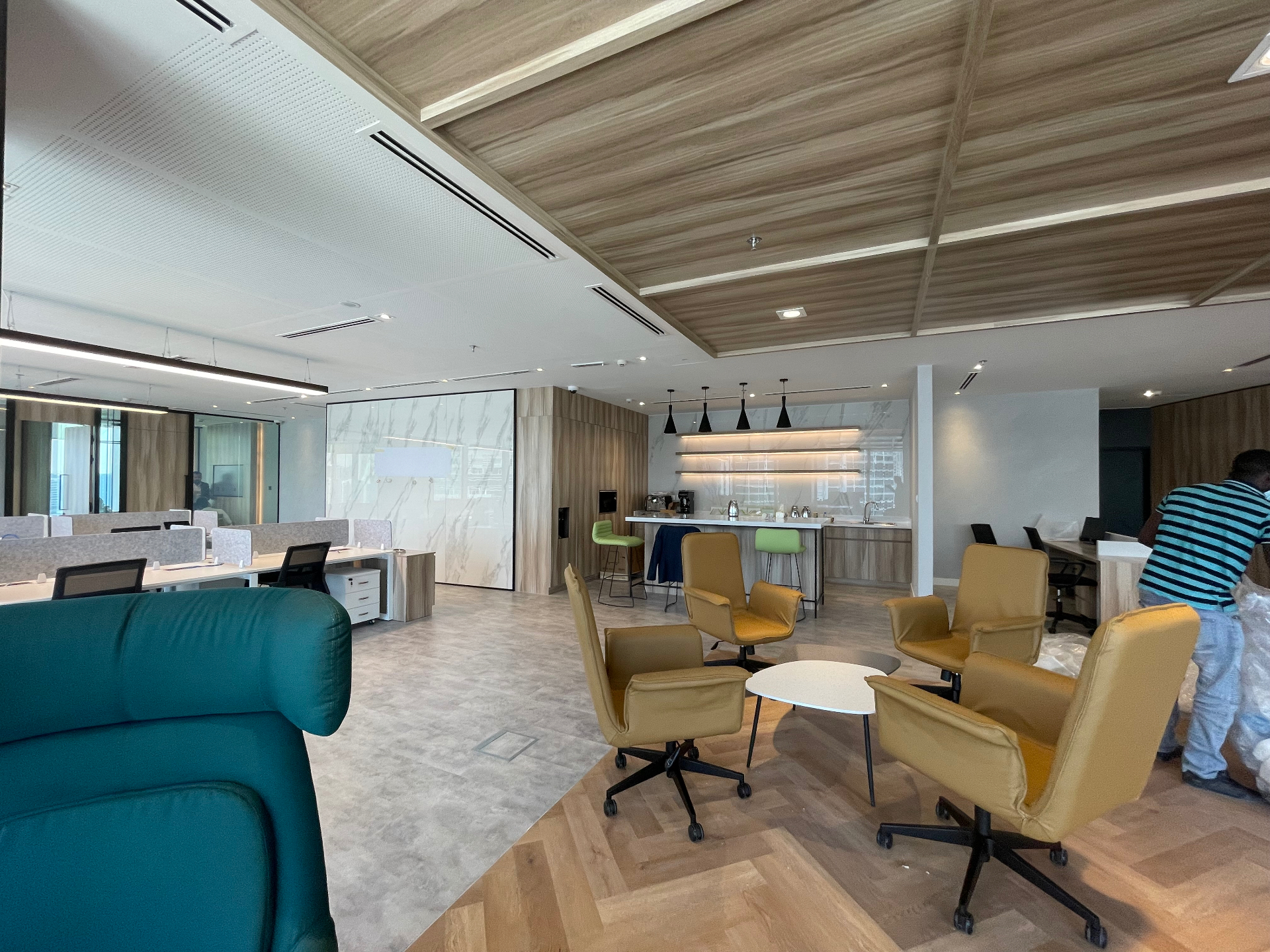 Open workstations, pantry island & breakout — corporate office delivered from design to execution by Ab & Zen Interior