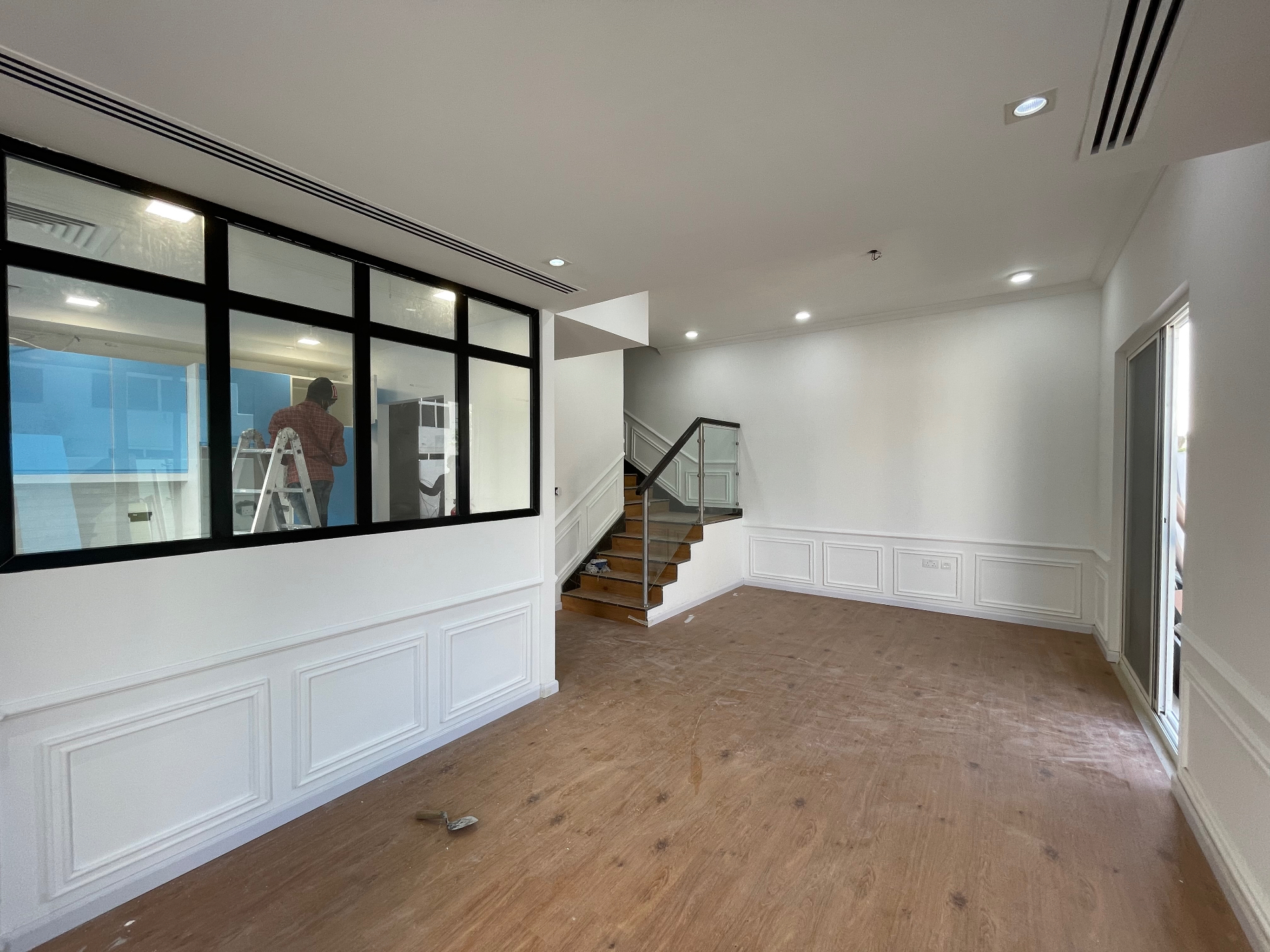 Open-plan living with steel-framed glazed partition — residential renovation in the Netherlands by Ab & Zen Interior